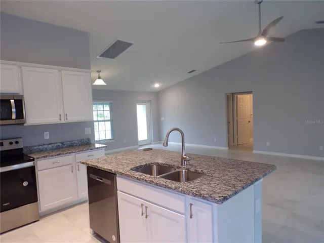 a metallic refrigerator freezer sitting in a kitchen