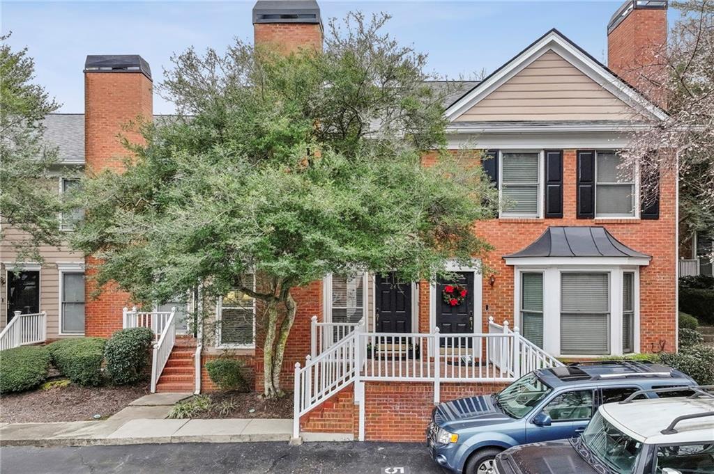 7500 Roswell Road, Unit 24 Sandy Springs, GA 30350 - Photo 1 of 45 a front view of a house with garden