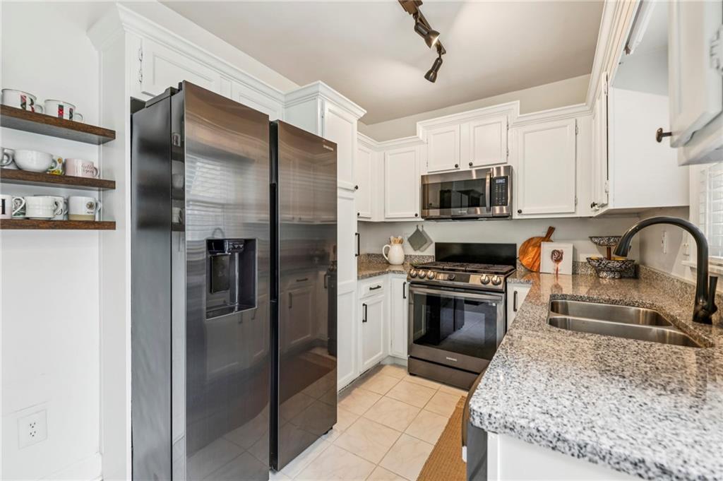 7500 Roswell Road, Unit 24 Sandy Springs, GA 30350 - Photo 11 of 45 a kitchen with granite countertop a refrigerator and a sink