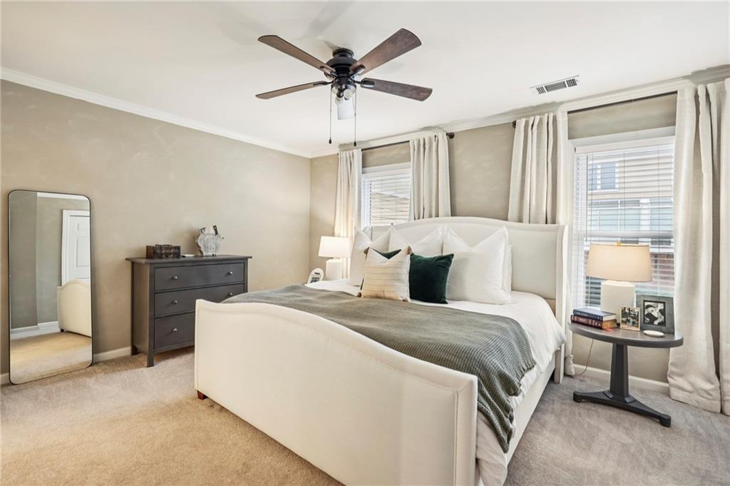 7500 Roswell Road, Unit 24 Sandy Springs, GA 30350 - Photo 15 of 45 a bedroom with a bed and a chandelier