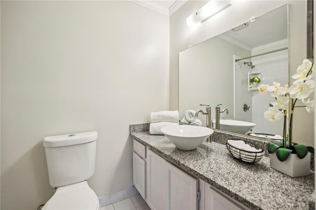 7500 Roswell Road, Unit 24 Sandy Springs, GA 30350 - Photo 16 of 45 a bathroom with a granite countertop sink and a mirror
