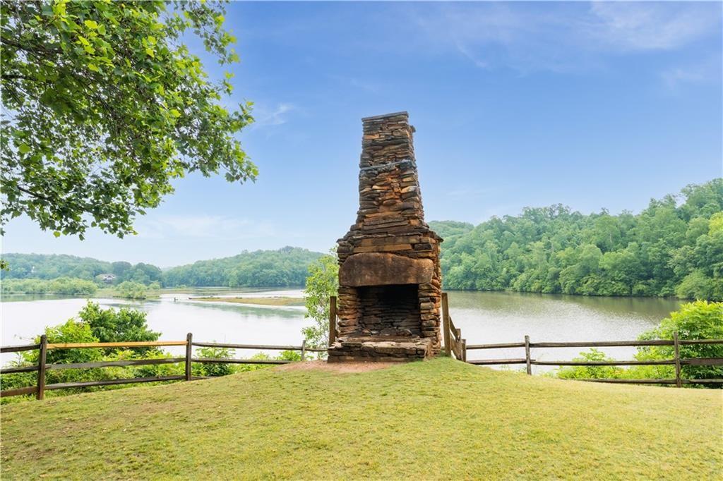 7500 Roswell Road, Unit 24 Sandy Springs, GA 30350 - Photo 43 of 45 a view of a lake with a big yard and large trees