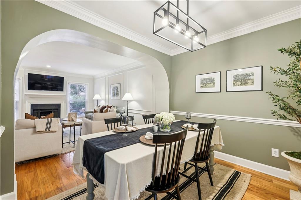 7500 Roswell Road, Unit 24 Sandy Springs, GA 30350 - Photo 7 of 45 a view of a dining room with furniture a fireplace and wooden floor