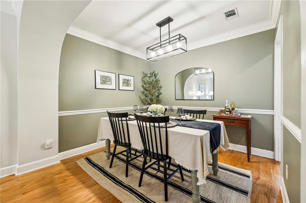 7500 Roswell Road, Unit 24 Sandy Springs, GA 30350 - Photo 8 of 45 a view of a dining room with furniture a chandelier and wooden floor