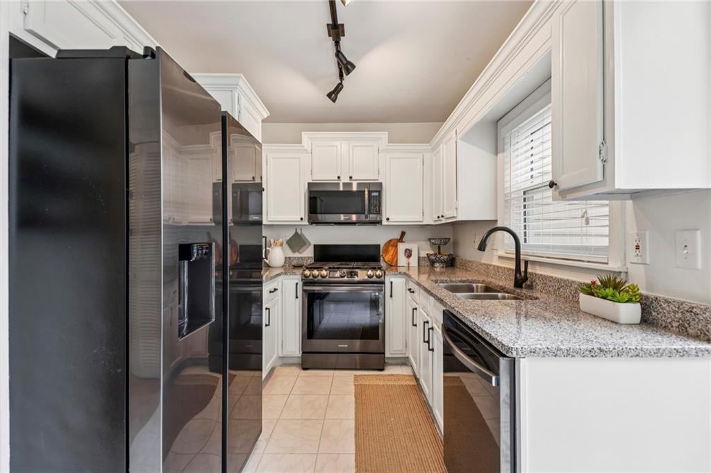 7500 Roswell Road, Unit 24 Sandy Springs, GA 30350 - Photo 10 of 45 a kitchen with a sink a stove and refrigerator