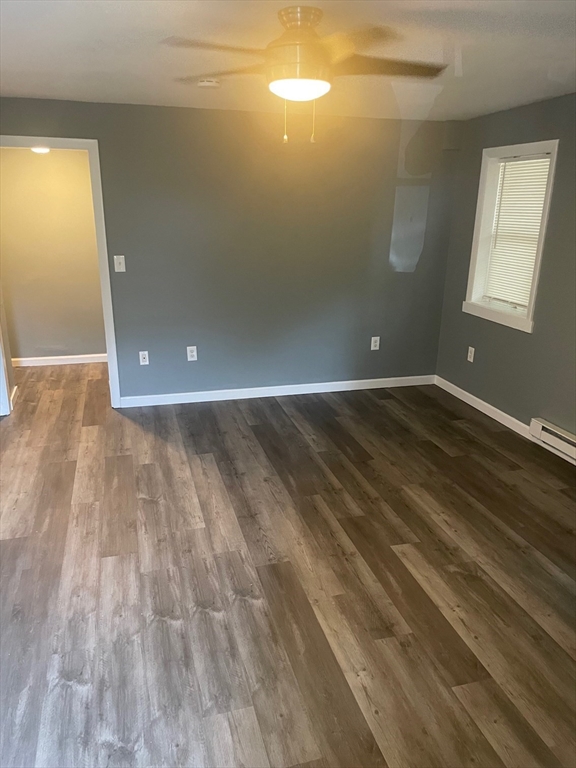 37 Oak Avenue, Unit 2 Worcester, MA 01605 - Photo 2 of 8 an empty room with wooden floor and windows