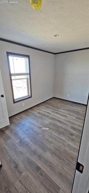 7075 North Ramah Highway Yoder, CO 80864 - Photo 13 of 13 an empty room with wooden floor and windows