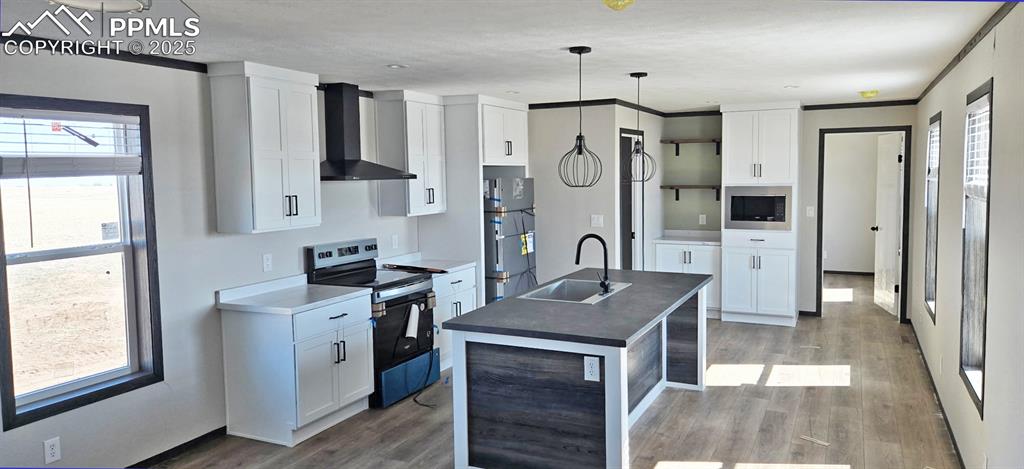 7075 North Ramah Highway Yoder, CO 80864 - Photo 3 of 13 a kitchen with stainless steel appliances granite countertop a sink stove and refrigerator