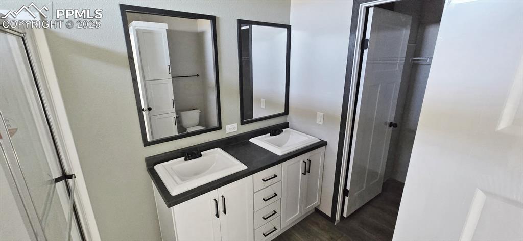 7075 North Ramah Highway Yoder, CO 80864 - Photo 7 of 13 a bathroom with a sink a mirror and a shower