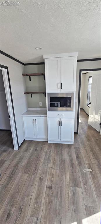 7075 North Ramah Highway Yoder, CO 80864 - Photo 9 of 13 a view of a kitchen with wooden floor and electronic appliances
