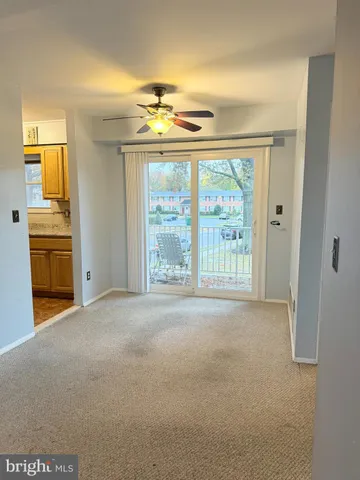 a kitchen with stainless steel appliances granite countertop a refrigerator a sink dishwasher a stove and white countertops with wooden floor