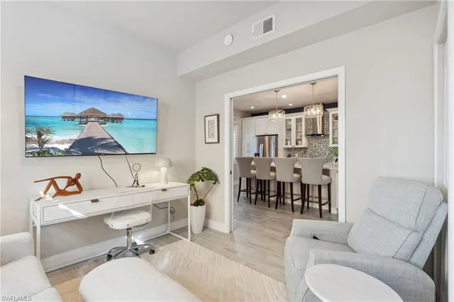 a living room with furniture a dining table and a piano table