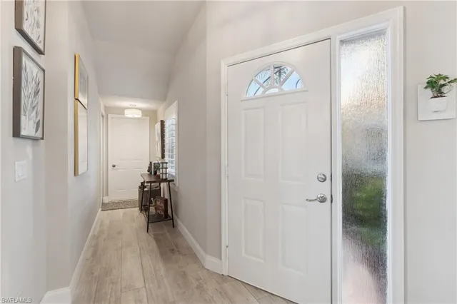 a view of a hallway with wooden floor and closet
