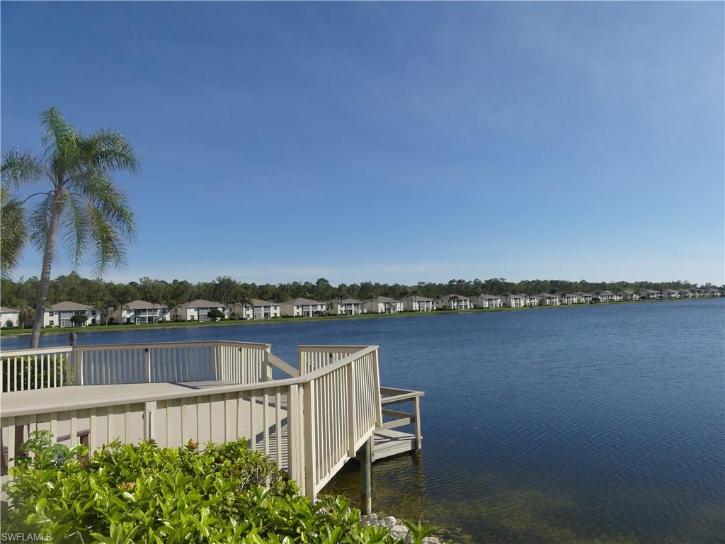 1747 Reuven Circle, Unit 1703 Naples, FL 34112 - Photo 20 of 31 a view of a lake with a city skyline in the background