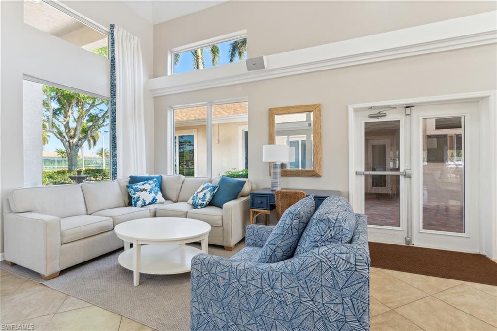 1747 Reuven Circle, Unit 1703 Naples, FL 34112 - Photo 25 of 31 a living room with furniture potted plant and a large window