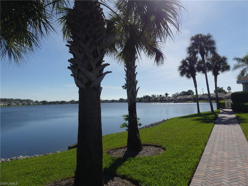 1747 Reuven Circle, Unit 1703 Naples, FL 34112 - Photo 31 of 31 a view of a lake with a palm tree