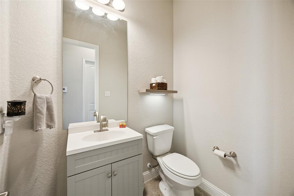 1701 Long Meadow Road Wylie, TX 75098 - Photo 22 of 30 a bathroom with a toilet sink and mirror