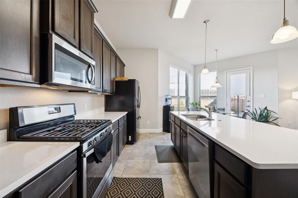1701 Long Meadow Road Wylie, TX 75098 - Photo 8 of 30 a kitchen with a sink stove and cabinets