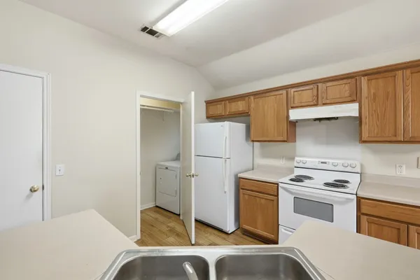 a kitchen with a stove and a refrigerator