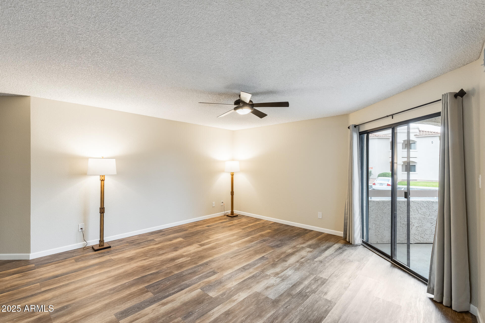 9151 West Greenway Road, Unit 111 Peoria, AZ 85381 - Photo 13 of 45 a view of a room with a ceiling fan