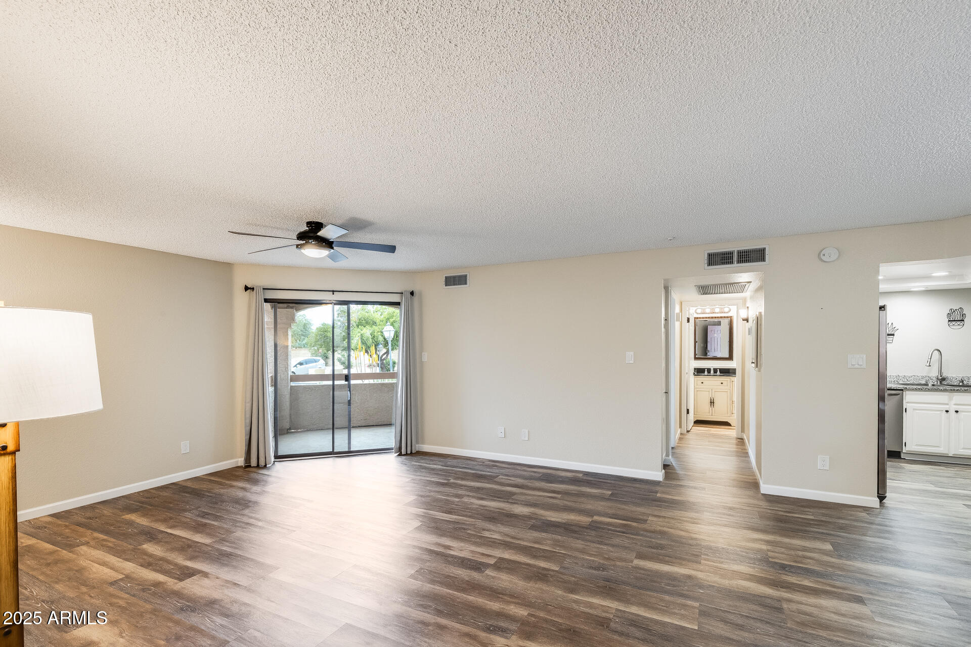 9151 West Greenway Road, Unit 111 Peoria, AZ 85381 - Photo 15 of 45 a view of an empty room with window and wooden floor