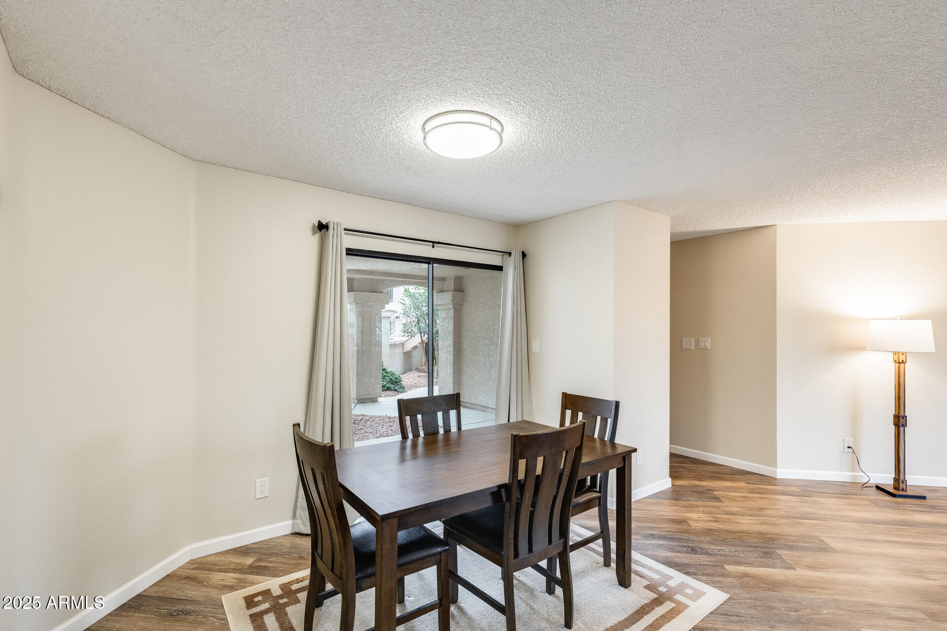 9151 West Greenway Road, Unit 111 Peoria, AZ 85381 - Photo 17 of 45 a view of a dining room with furniture and wooden floor