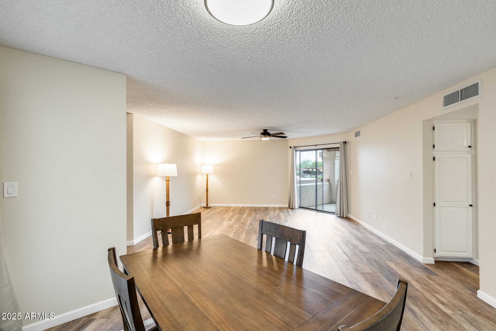 9151 West Greenway Road, Unit 111 Peoria, AZ 85381 - Photo 18 of 45 a view of a dining room with furniture and wooden floor