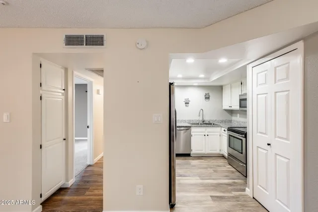 a kitchen with stainless steel appliances granite countertop a refrigerator and a stove top oven