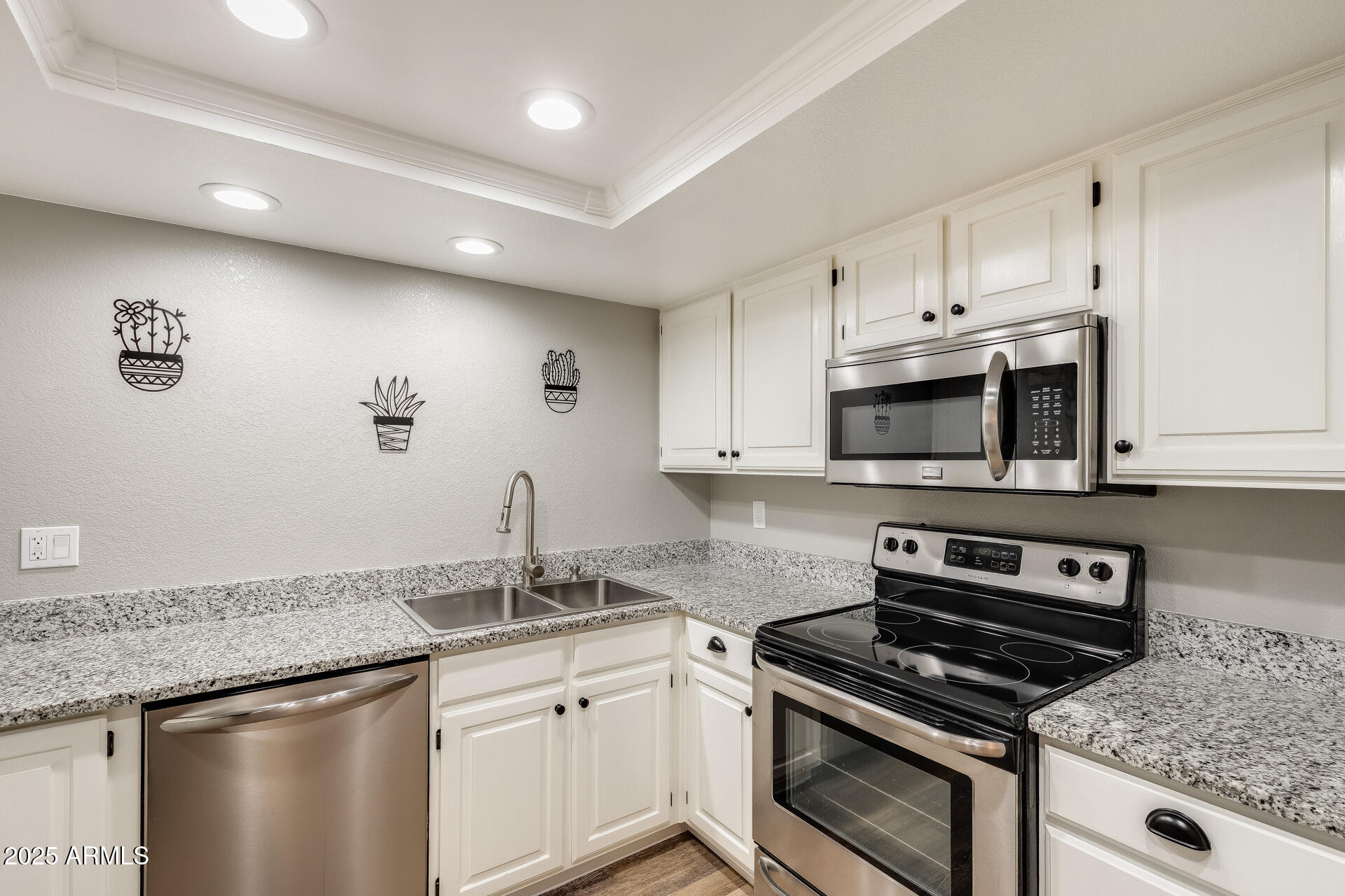 9151 West Greenway Road, Unit 111 Peoria, AZ 85381 - Photo 22 of 45 a kitchen with granite countertop a stove sink and cabinets