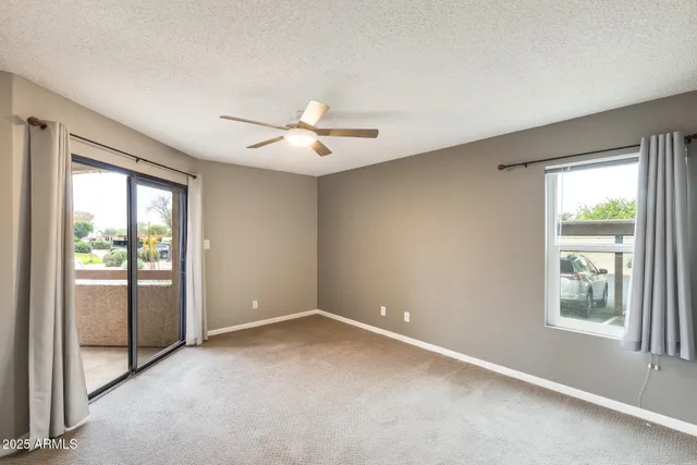 an empty room with windows and closet