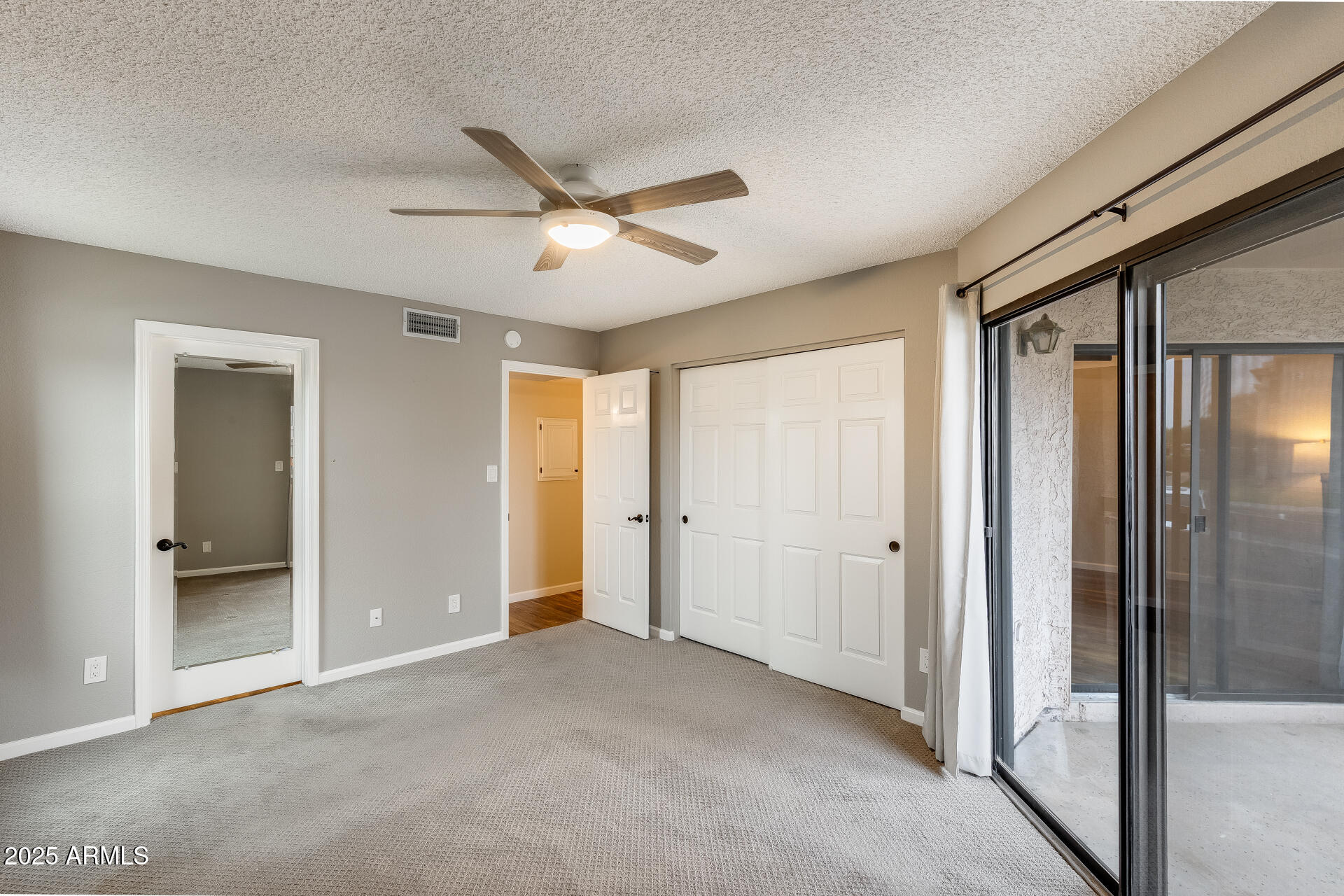 9151 West Greenway Road, Unit 111 Peoria, AZ 85381 - Photo 29 of 45 a view of empty room with wooden floor and fan