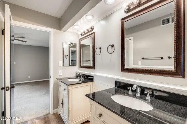 a bathroom with a sink double vanity and a mirror