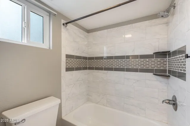 a bathroom with a shower and a toilet