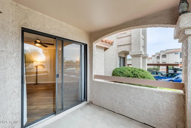 a view of a swimming pool with a lawn chairs and couches