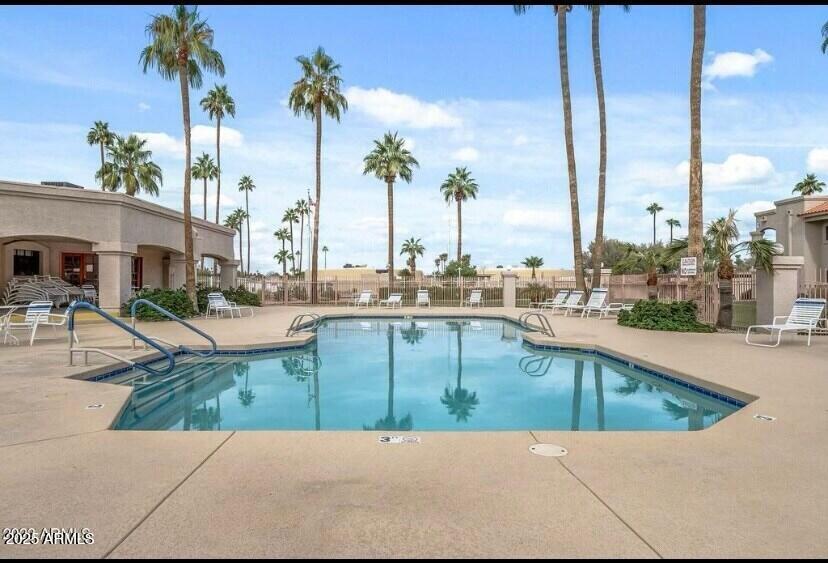9151 West Greenway Road, Unit 111 Peoria, AZ 85381 - Photo 40 of 45 a view of a swimming pool with a lawn chairs and couches