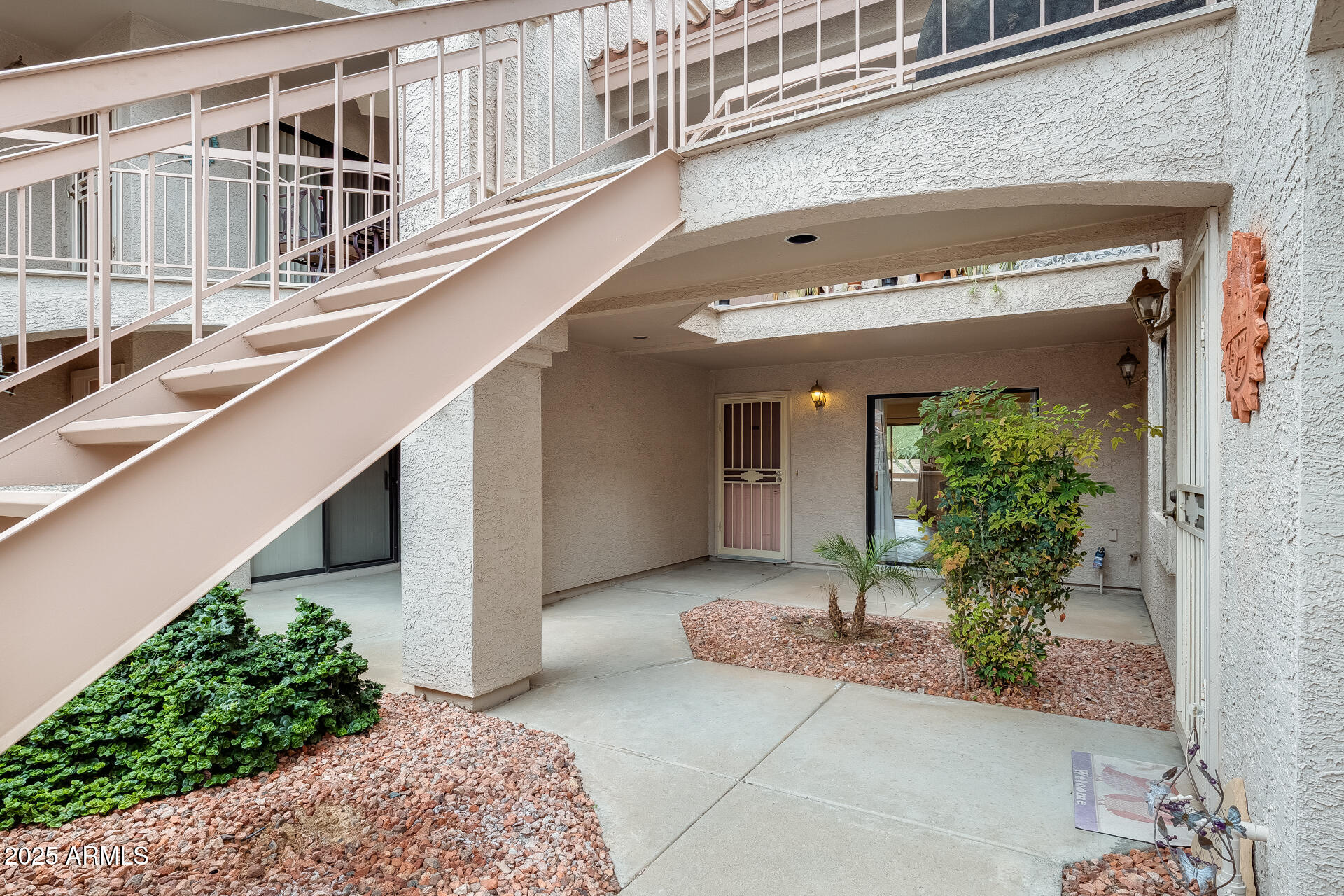 9151 West Greenway Road, Unit 111 Peoria, AZ 85381 - Photo 7 of 45 a view of a building with a window and potted plants