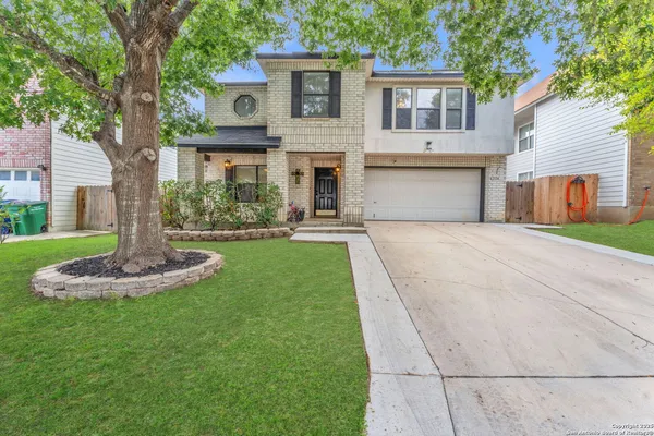 a front view of house with yard and green space