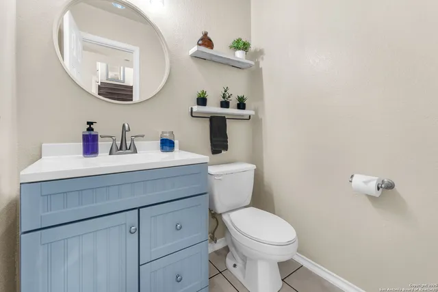 a bathroom with a toilet a sink and mirror