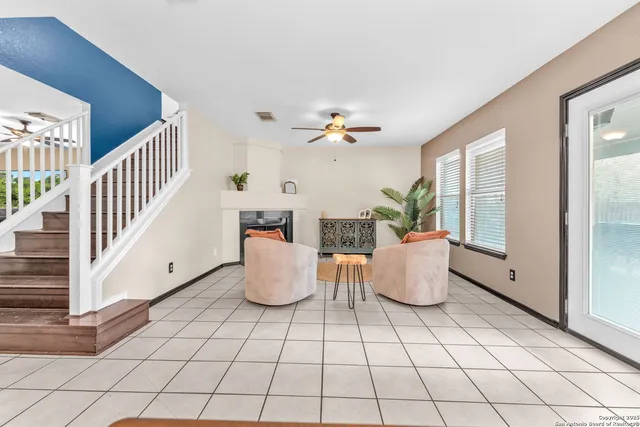 a living room with furniture and white walls