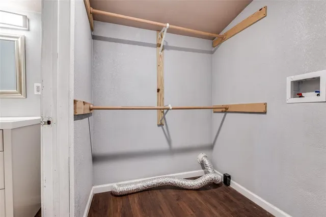 a view of walk in closet with clothes