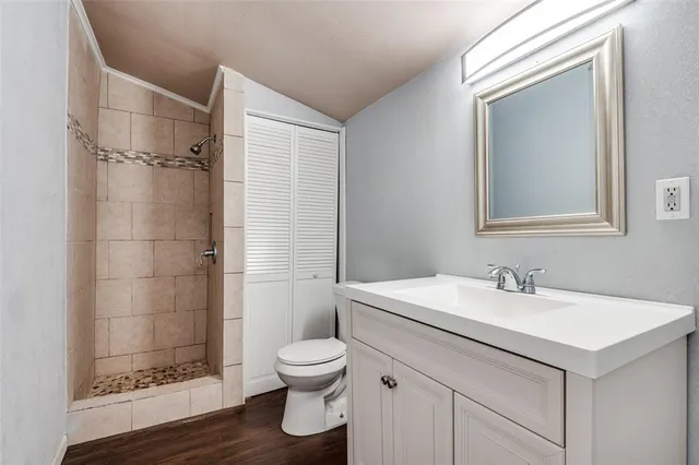 a bathroom with a sink toilet and shower