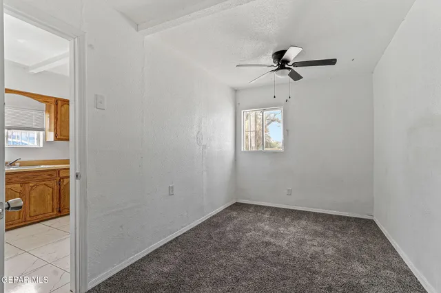 an empty room with windows and cabinet