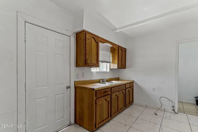 a utility room with sink dryer and washer