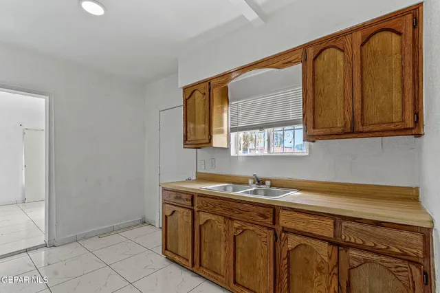 a kitchen with stainless steel appliances granite countertop a sink and cabinets with wooden floor