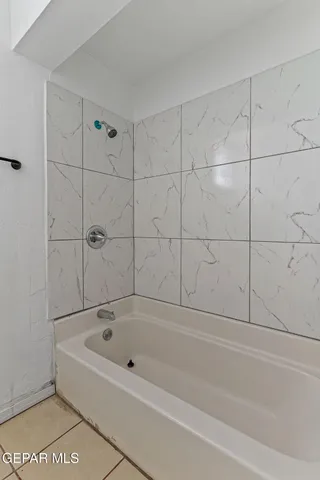 a bathroom with a bathtub and shower