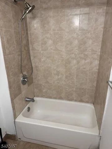 a bathroom with a tub and a shower