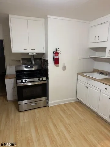 a kitchen with a stove and white cabinets