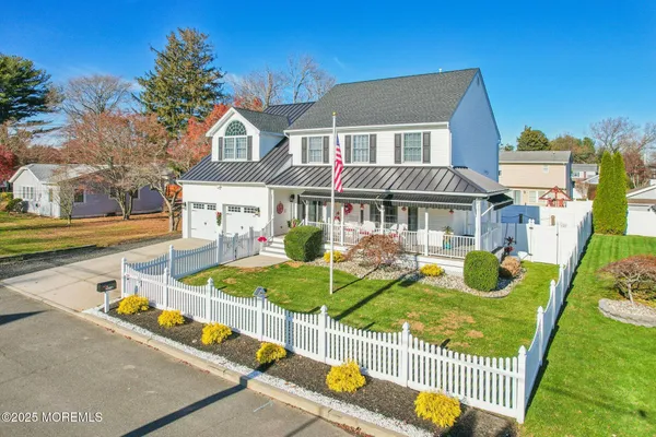 a view of an house with backyard and sitting area