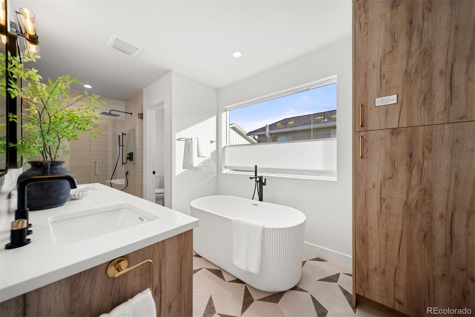 2452 South Cherokee Street Denver, CO 80223 - Photo 17 of 34 a bathroom with a sink toilet and mirror