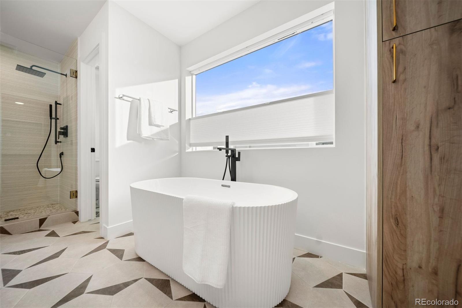 2452 South Cherokee Street Denver, CO 80223 - Photo 18 of 34 a bathroom with a sink a toilet and shower